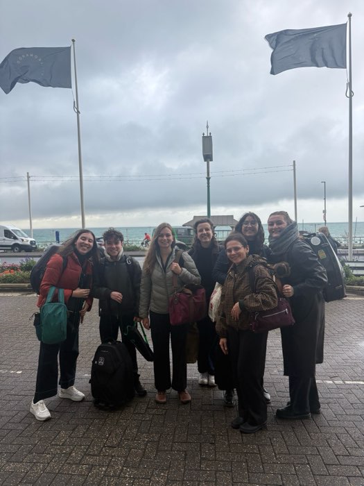 Cor8 members together by the seafront in 2026
